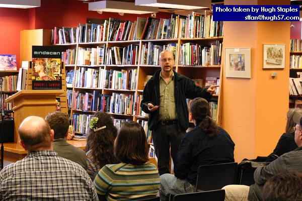 Rob Sawyer performs a passage from his new novel, MINDSCAN,<br />before a small, but loyal and attentive crowd of about 15 people.