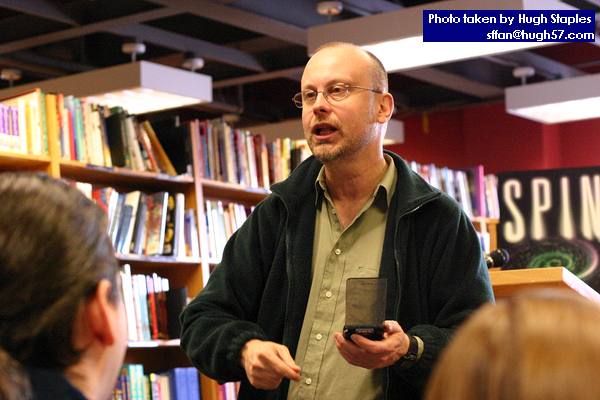 Rob Sawyer performs a passage from his new novel, MINDSCAN, before a small, but loyal and attentive crowd of about 15 people.