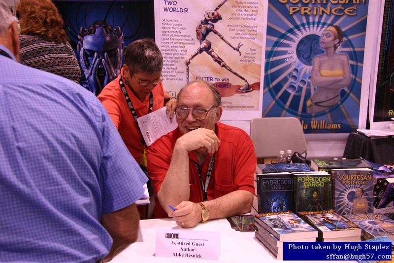 Mike Resnick signs autographs at Edge Press table